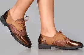 brown brogues combining a patent leather toe with a glittery/suede upper. 
