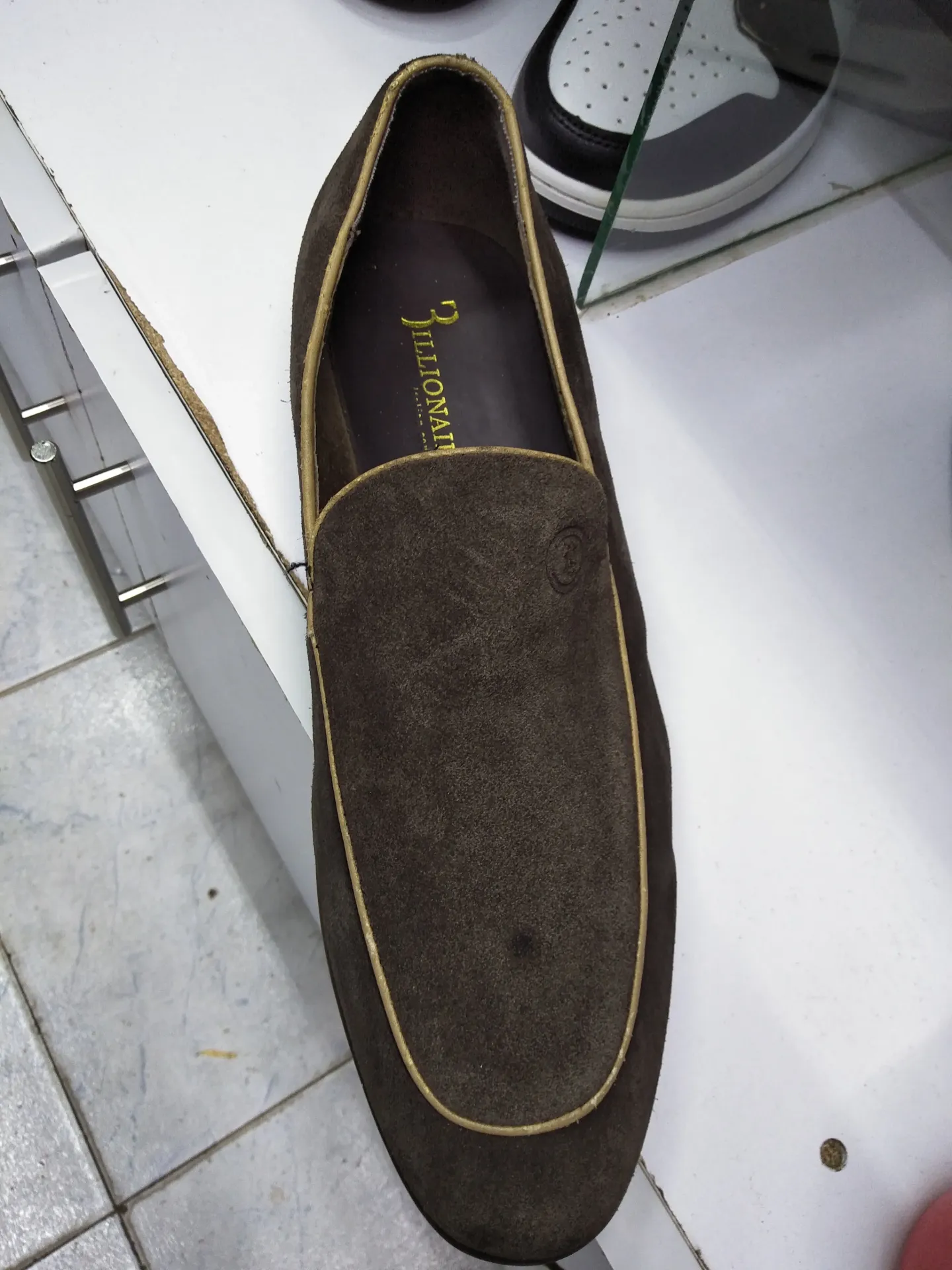 brown suede loafers with light-colored piping.