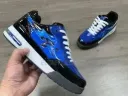 blue and black sneakers with white laces.  