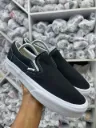 black Vans Slip-On sneakers.